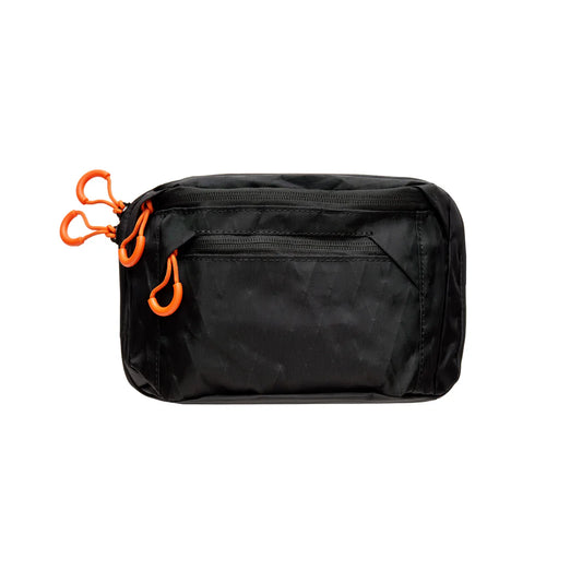 Black waist bag with orange zipper pulls on a white background